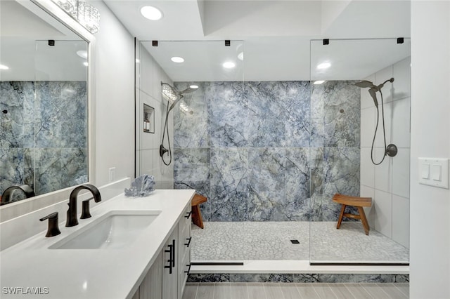 bathroom featuring tile walls, vanity, and a tile shower