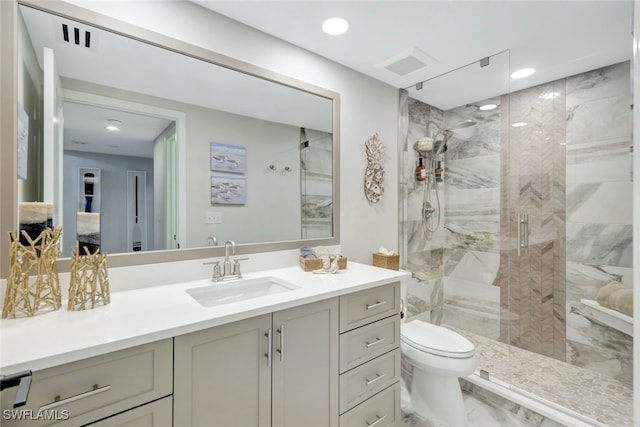 bathroom featuring toilet, walk in shower, and vanity