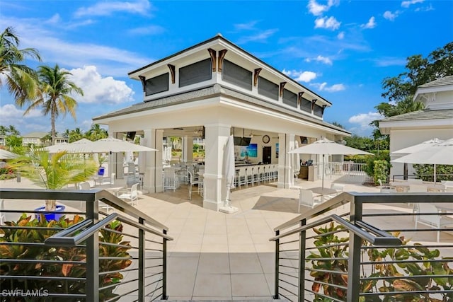 exterior space featuring an outdoor bar and a patio