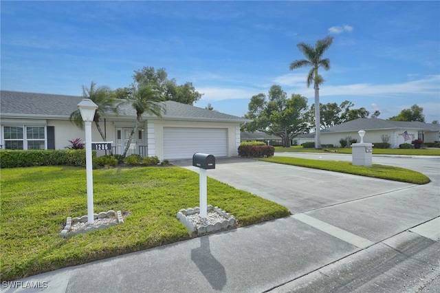 single story home featuring a garage and a front lawn