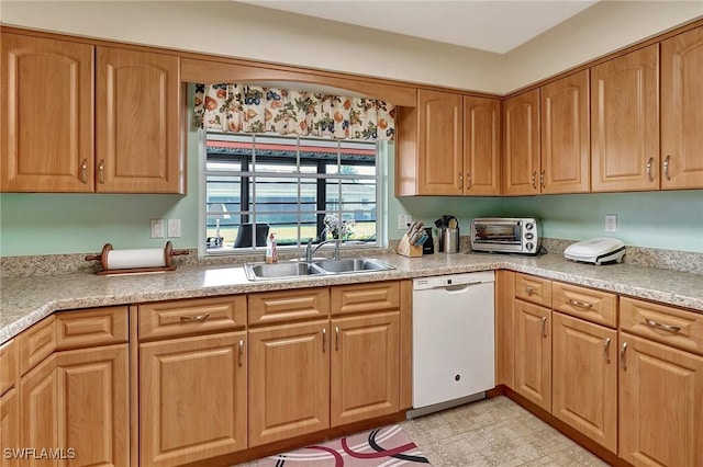 kitchen featuring white dishwasher and sink