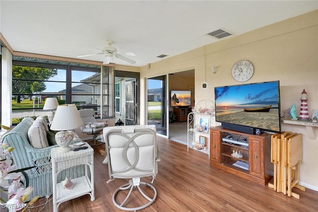 living room featuring hardwood / wood-style flooring and ceiling fan