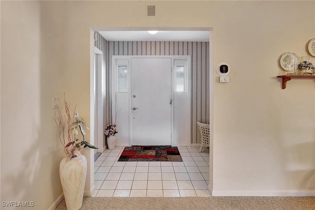 entryway with light tile patterned flooring