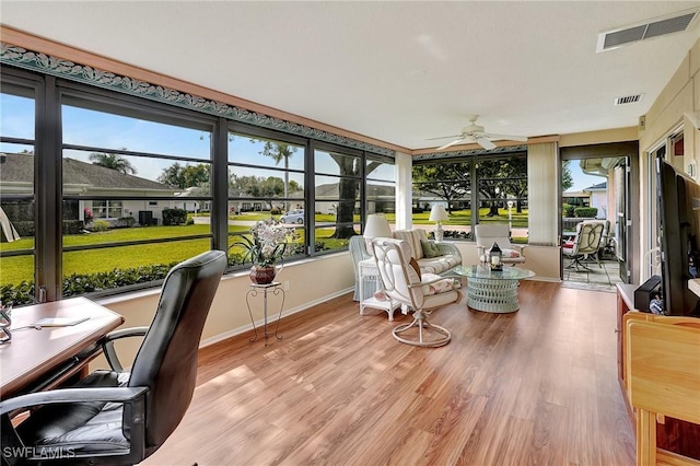 sunroom / solarium featuring ceiling fan