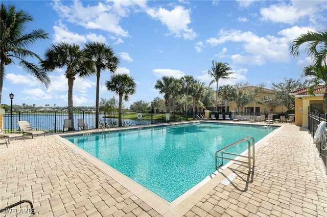 view of pool with a patio area and a water view