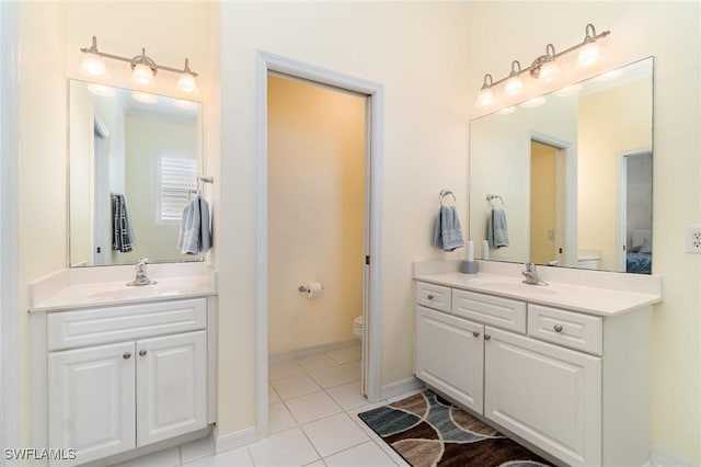 bathroom with toilet, tile patterned floors, and vanity