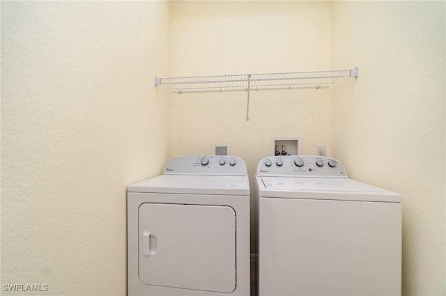 clothes washing area featuring washer and clothes dryer