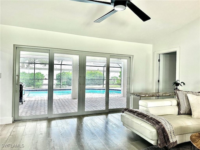 bedroom with access to exterior, wood-type flooring, and ceiling fan