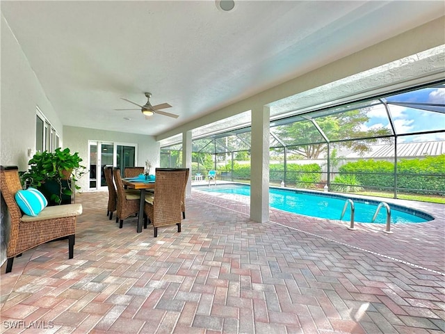 view of pool featuring a lanai, a patio area, and ceiling fan