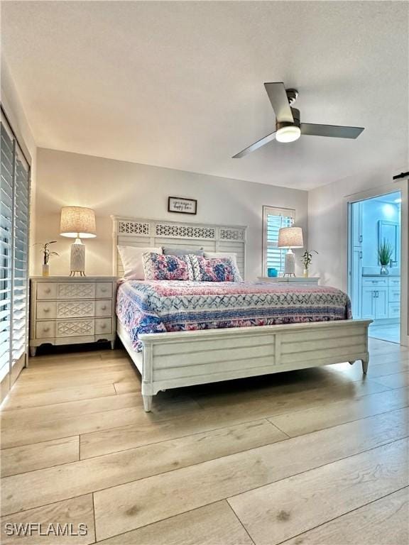 9553 Campbell Cir, Naples, FL 34109 - bedroom with light wood-style floors, ensuite bath, and a ceiling fan