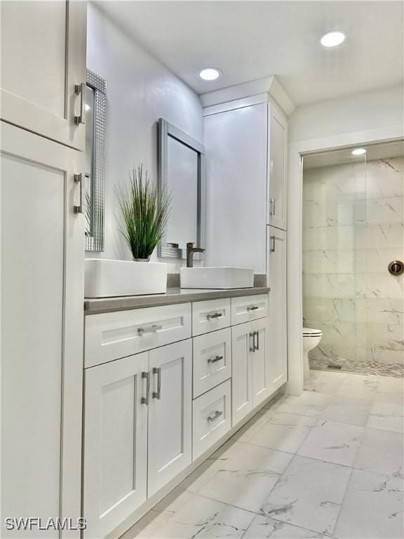 bathroom featuring vanity, toilet, and a shower