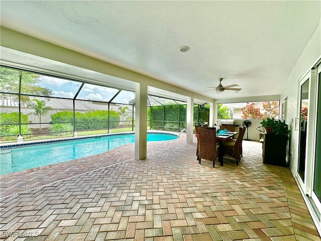 view of swimming pool with a lanai, a patio, and ceiling fan