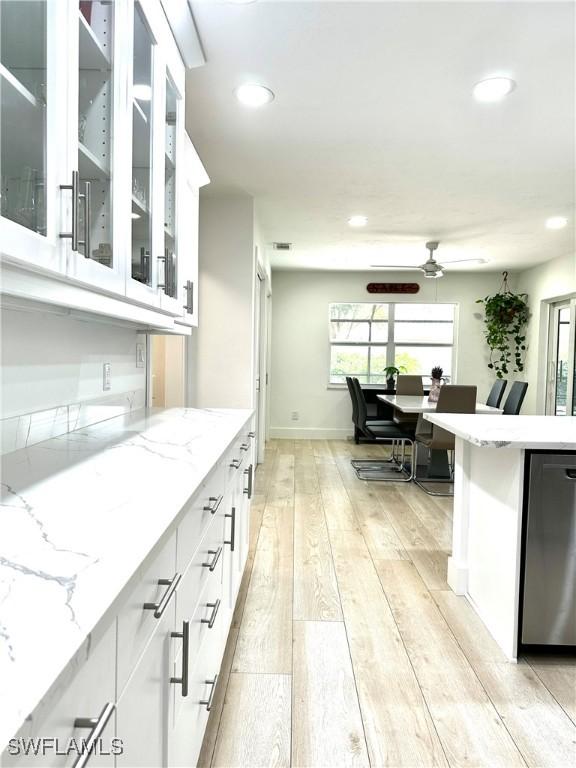 9553 Campbell Cir, Naples, FL 34109 - kitchen with white cabinetry, light stone countertops, light wood-type flooring, ceiling fan, and recessed lighting