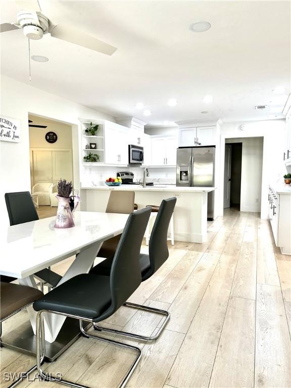 dining area featuring sink and light hardwood / wood-style floors