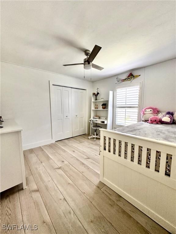 unfurnished bedroom with ceiling fan, light hardwood / wood-style floors, and a closet