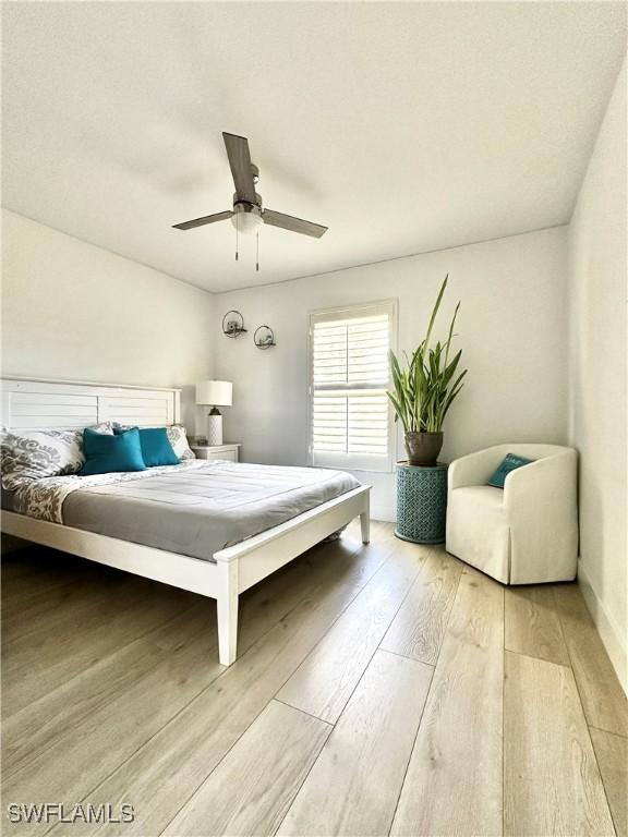 bedroom with ceiling fan and hardwood / wood-style floors