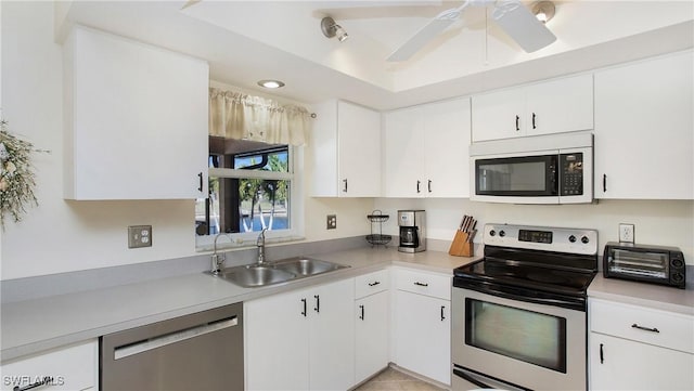 kitchen with white cabinetry, ceiling fan, appliances with stainless steel finishes, and sink