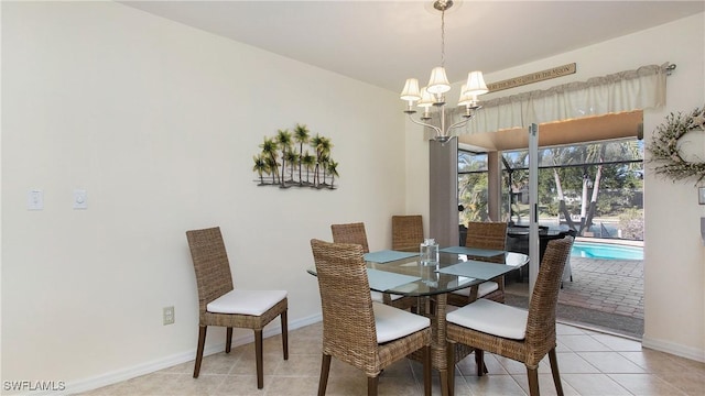 dining area with light tile patterned floors and an inviting chandelier