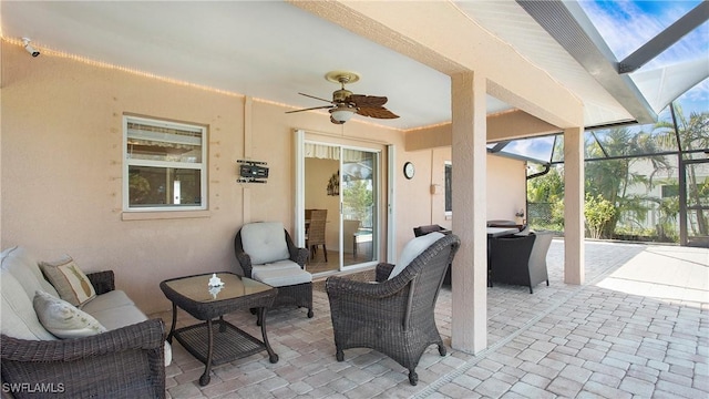 view of patio with a lanai, an outdoor hangout area, and ceiling fan