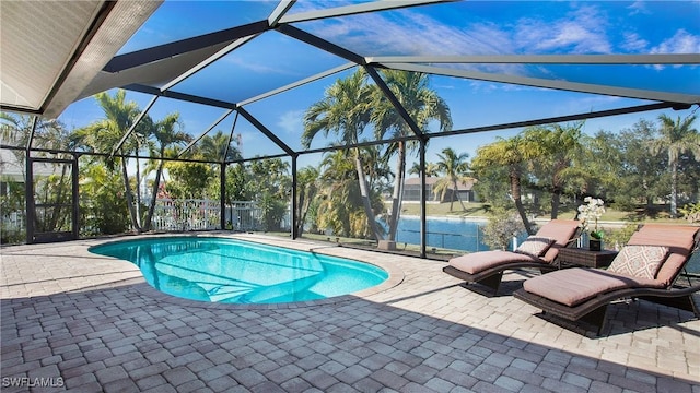 view of pool with a patio area and glass enclosure