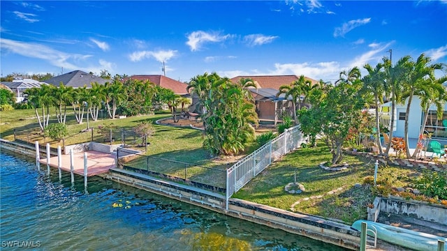 dock area featuring a water view, a yard, and glass enclosure