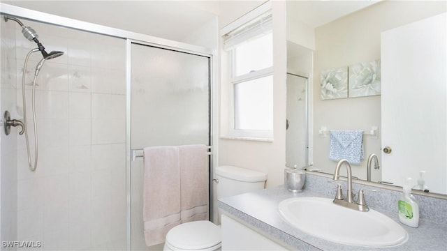 bathroom with vanity, an enclosed shower, and toilet