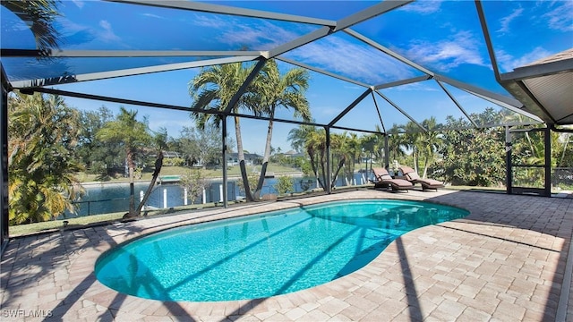 view of pool with a patio and glass enclosure