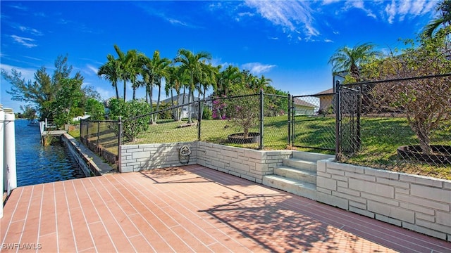 view of patio featuring a water view and a boat dock