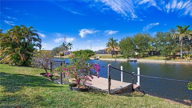 dock area featuring a water view and a lawn