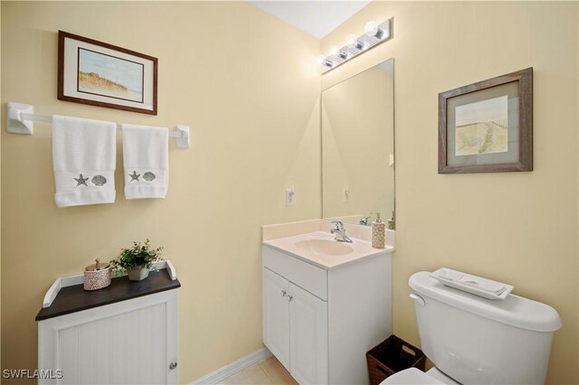 bathroom with tile patterned floors, vanity, and toilet