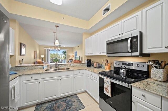 kitchen with stainless steel appliances, sink, white cabinets, light tile patterned floors, and kitchen peninsula