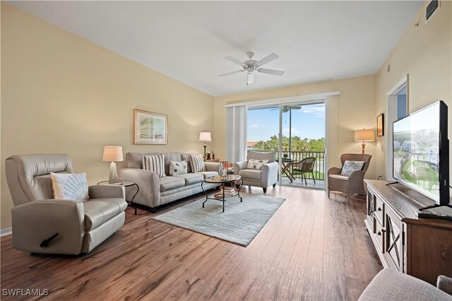 living room with hardwood / wood-style flooring and ceiling fan