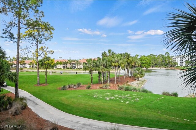 view of community featuring a water view and a lawn