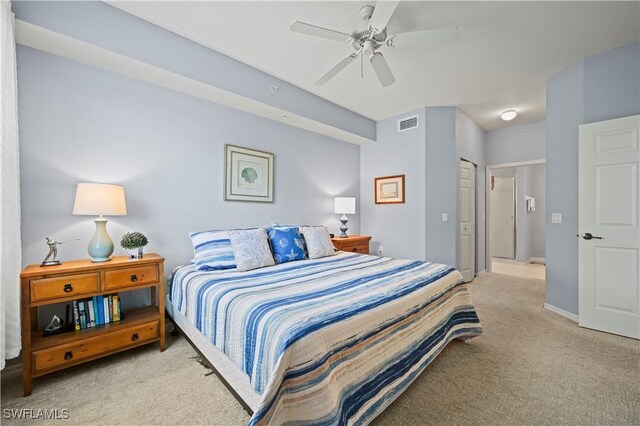 carpeted bedroom featuring ceiling fan and a closet