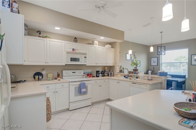 kitchen featuring white appliances, kitchen peninsula, hanging light fixtures, and white cabinetry