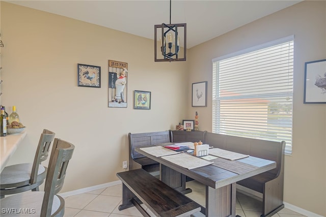 dining area with an inviting chandelier and light tile patterned floors