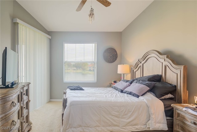 carpeted bedroom featuring lofted ceiling and ceiling fan