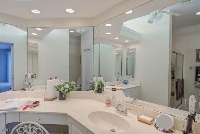 bathroom with an enclosed shower, ceiling fan, and vanity