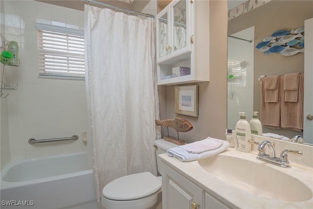 full bathroom featuring toilet, shower / bath combination with curtain, and vanity