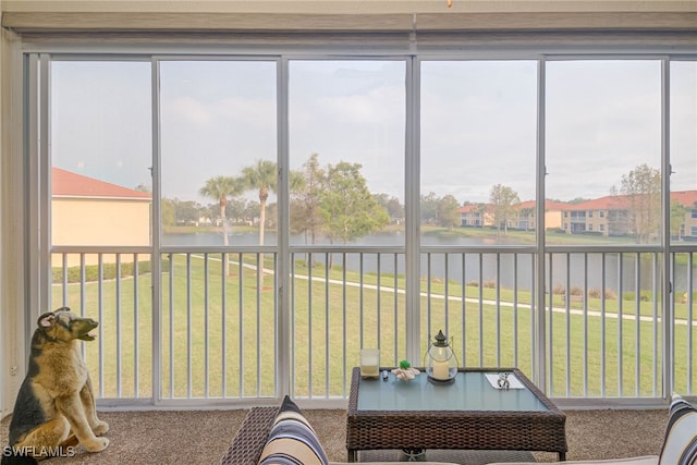 sunroom / solarium with a water view