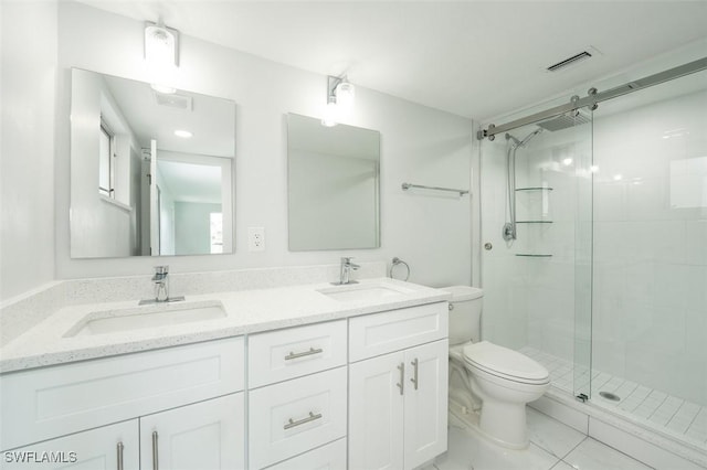 bathroom with vanity, a shower with shower door, and toilet