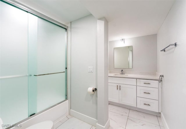 full bathroom with toilet, vanity, and bath / shower combo with glass door