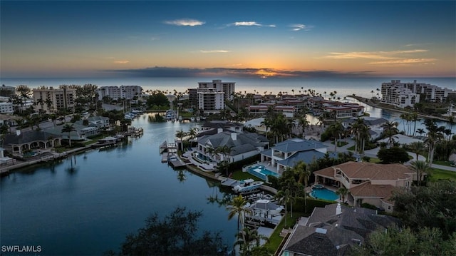 aerial view at dusk with a water view