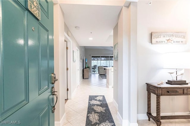 hall with light tile patterned floors