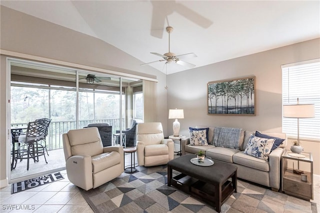 living room featuring ceiling fan, tile patterned floors, and vaulted ceiling