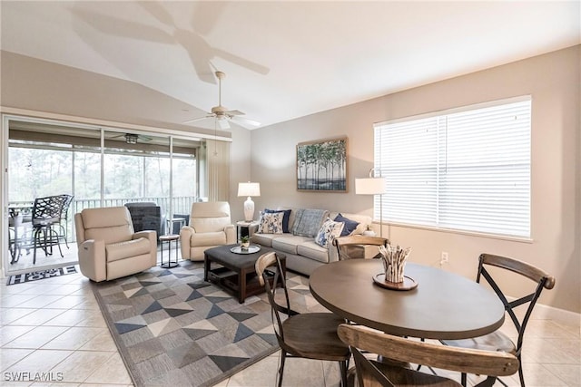 living room featuring light tile patterned floors, vaulted ceiling, and ceiling fan