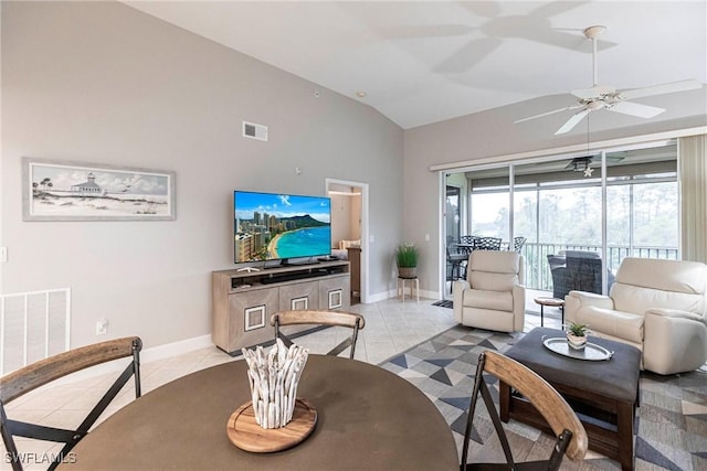 living room featuring vaulted ceiling, light tile patterned floors, and ceiling fan