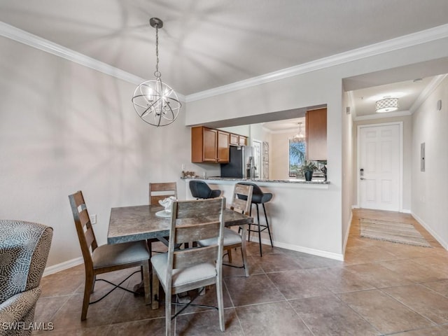 dining area with crown molding and a chandelier