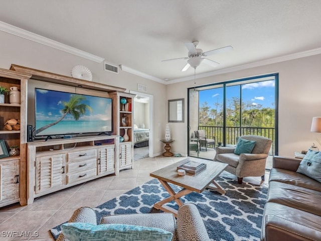 tiled living room with ceiling fan and crown molding