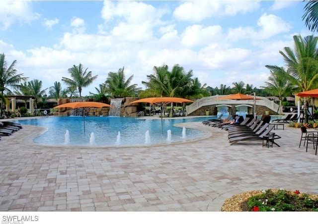 view of pool featuring pool water feature and a patio